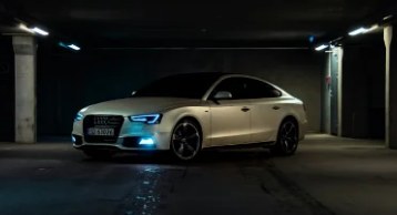 Silver Audi in a dark car park